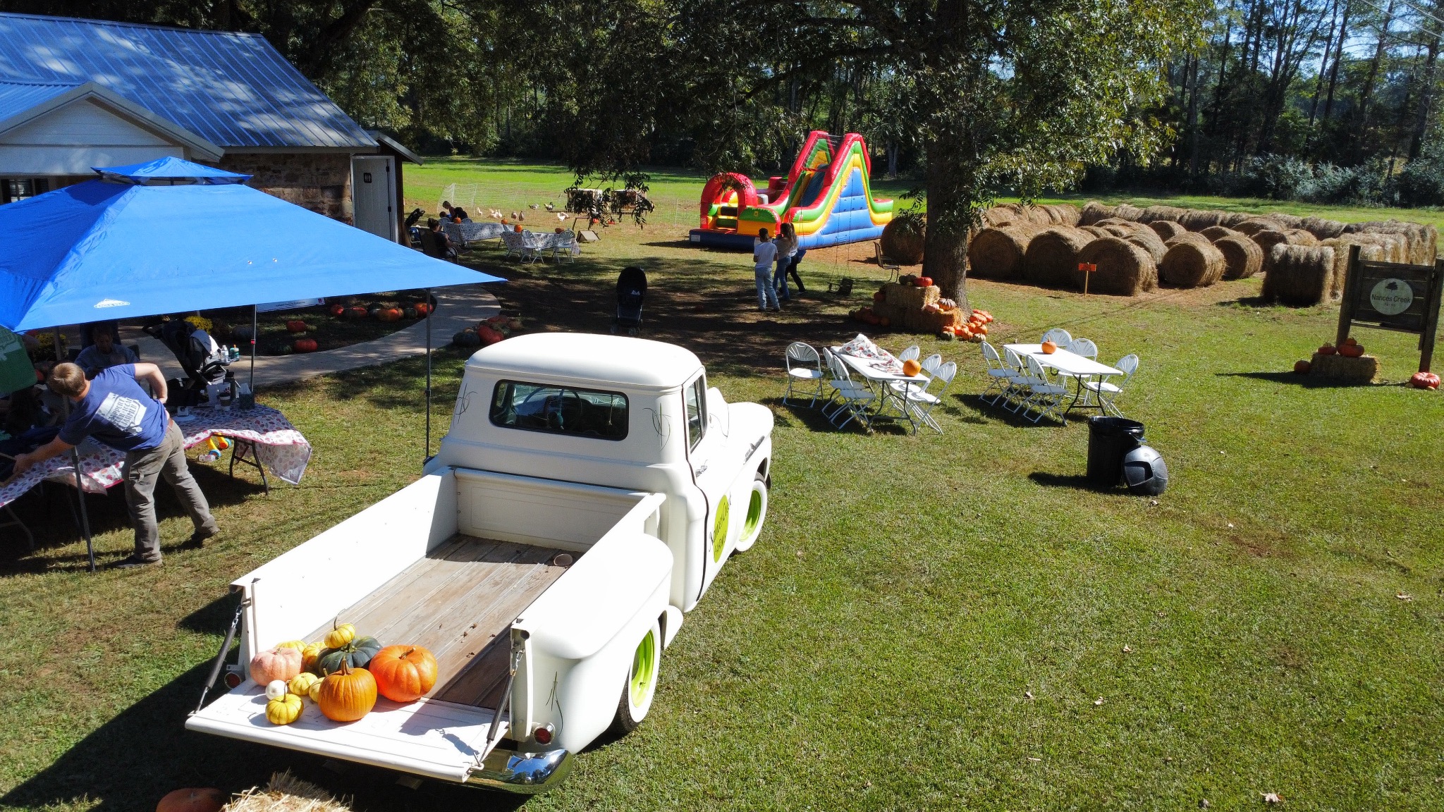 Farm yard with pumpkins, slides and picnic tables
